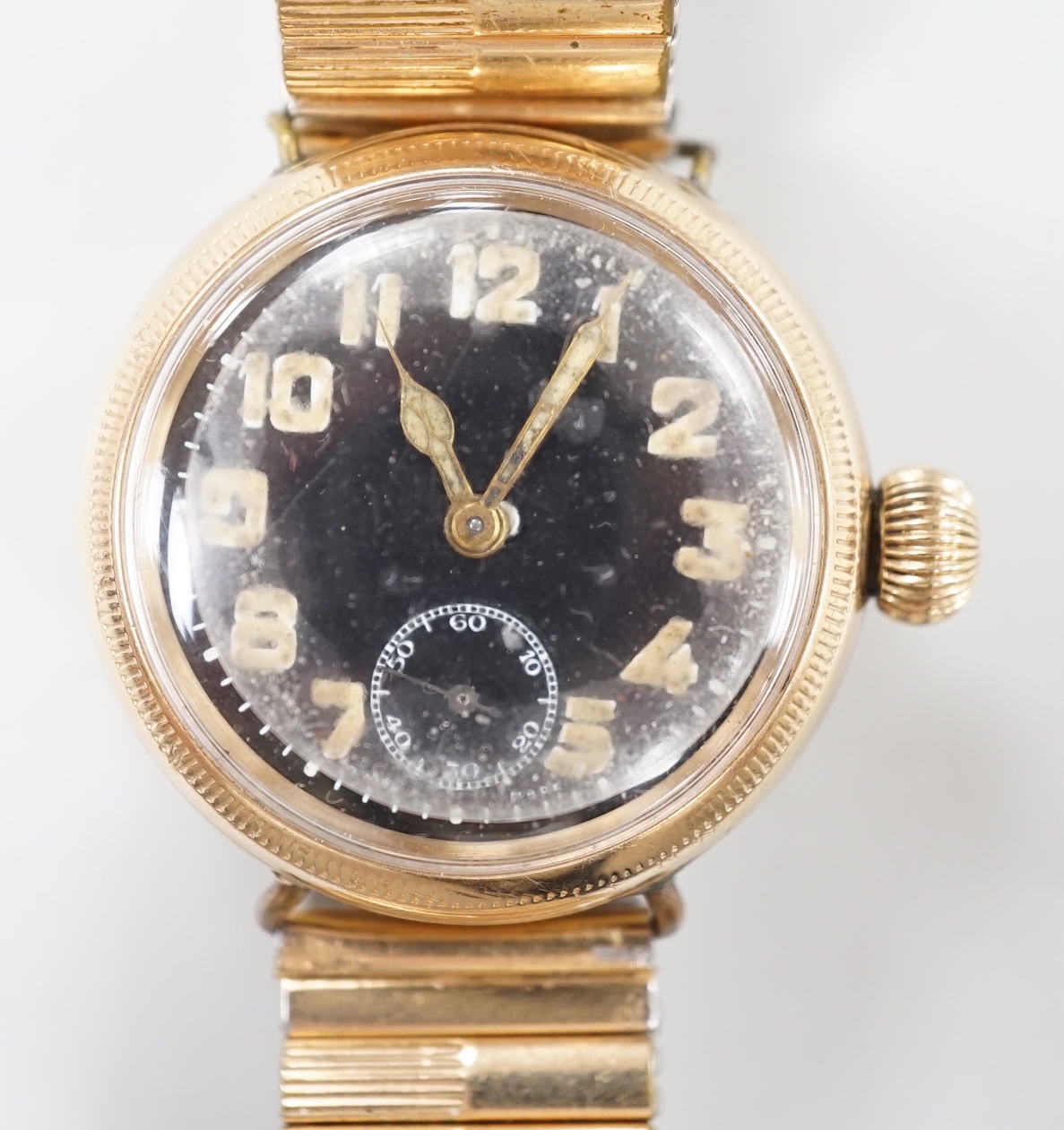 A gentleman's early 20th century 9ct gold Zenith military? manual wind wrist watch, with black Arabic dial and subsidiary seconds, case diameter 35mm, on associated later flexible strap.